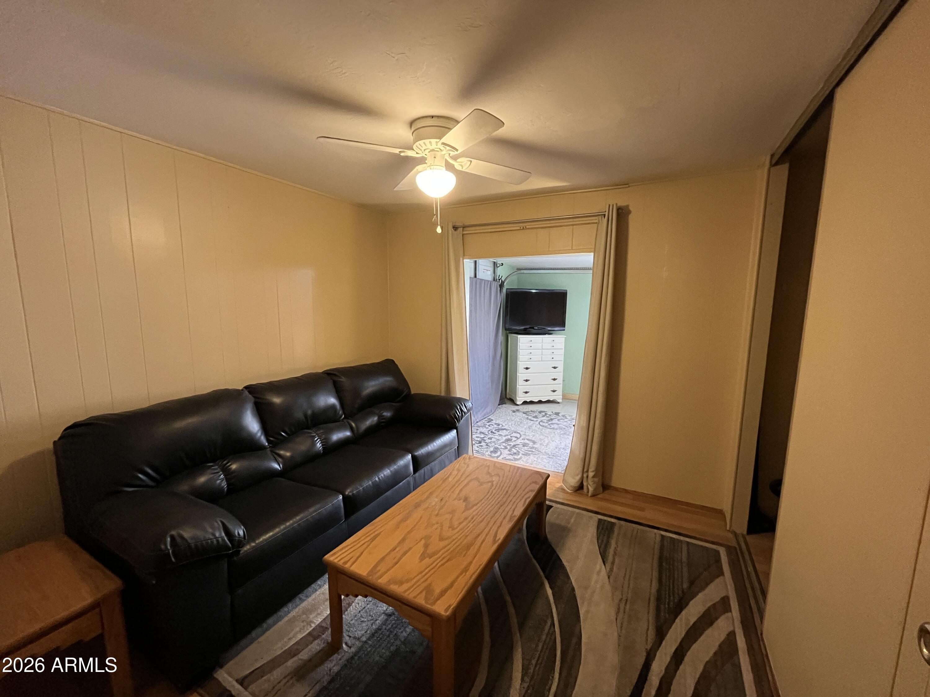 9302 East Broadway Road, Unit 179 Mesa, AZ 85208 - Photo 18 of 54 a living room with furniture and a ceiling fan