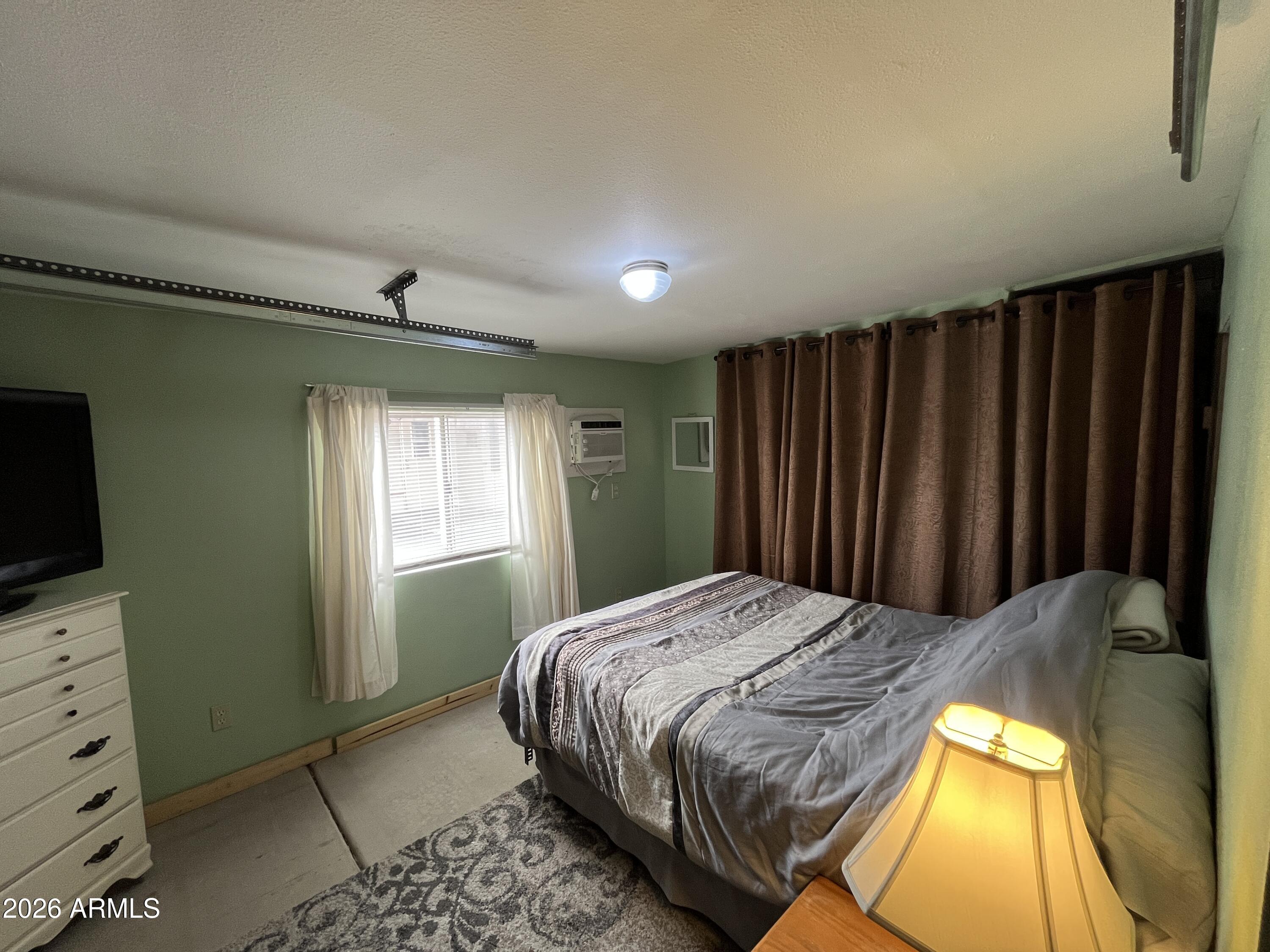 9302 East Broadway Road, Unit 179 Mesa, AZ 85208 - Photo 22 of 54 a bedroom with a bed and a television