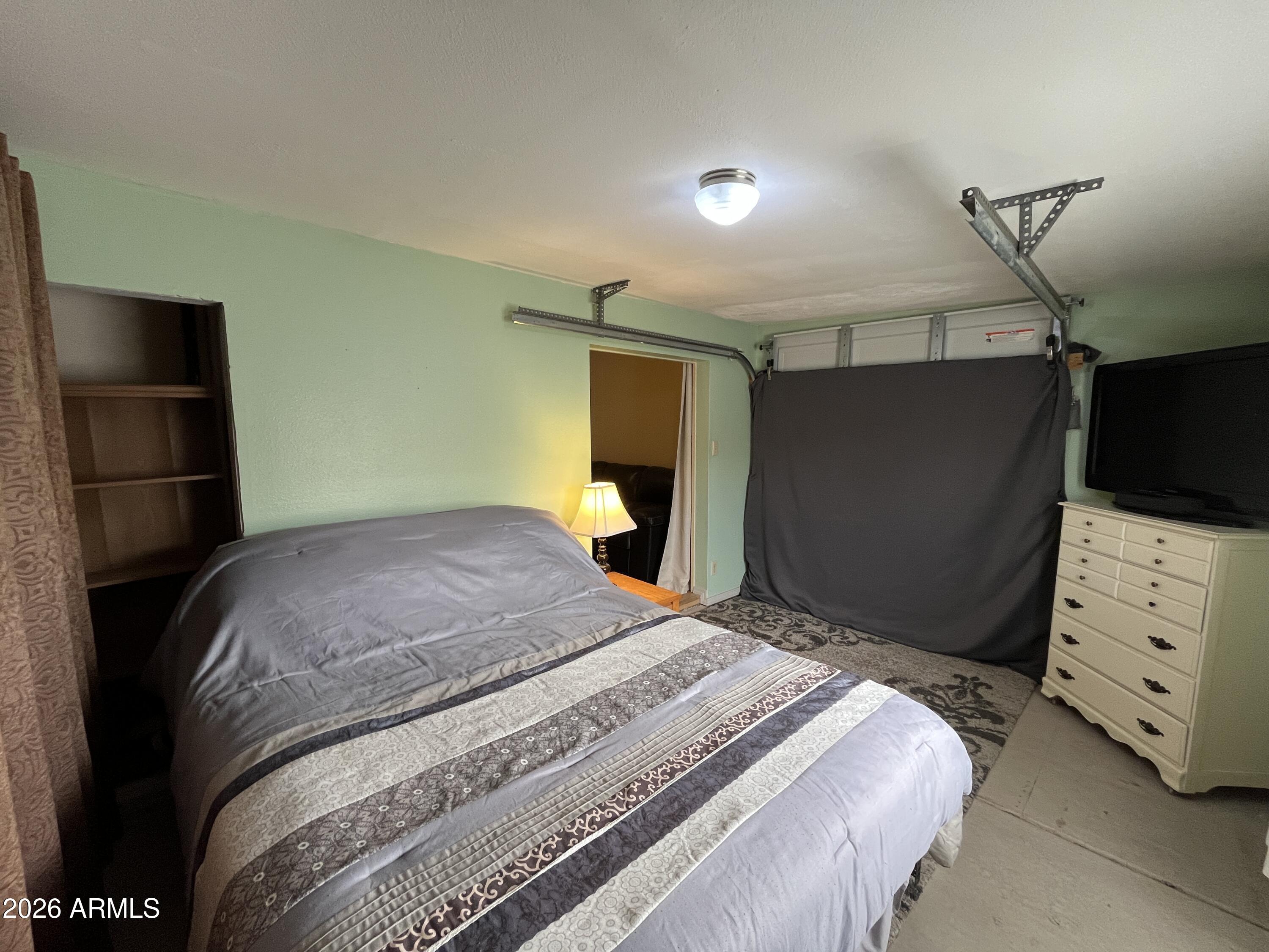 9302 East Broadway Road, Unit 179 Mesa, AZ 85208 - Photo 23 of 54 a bedroom with a bed and a television in it