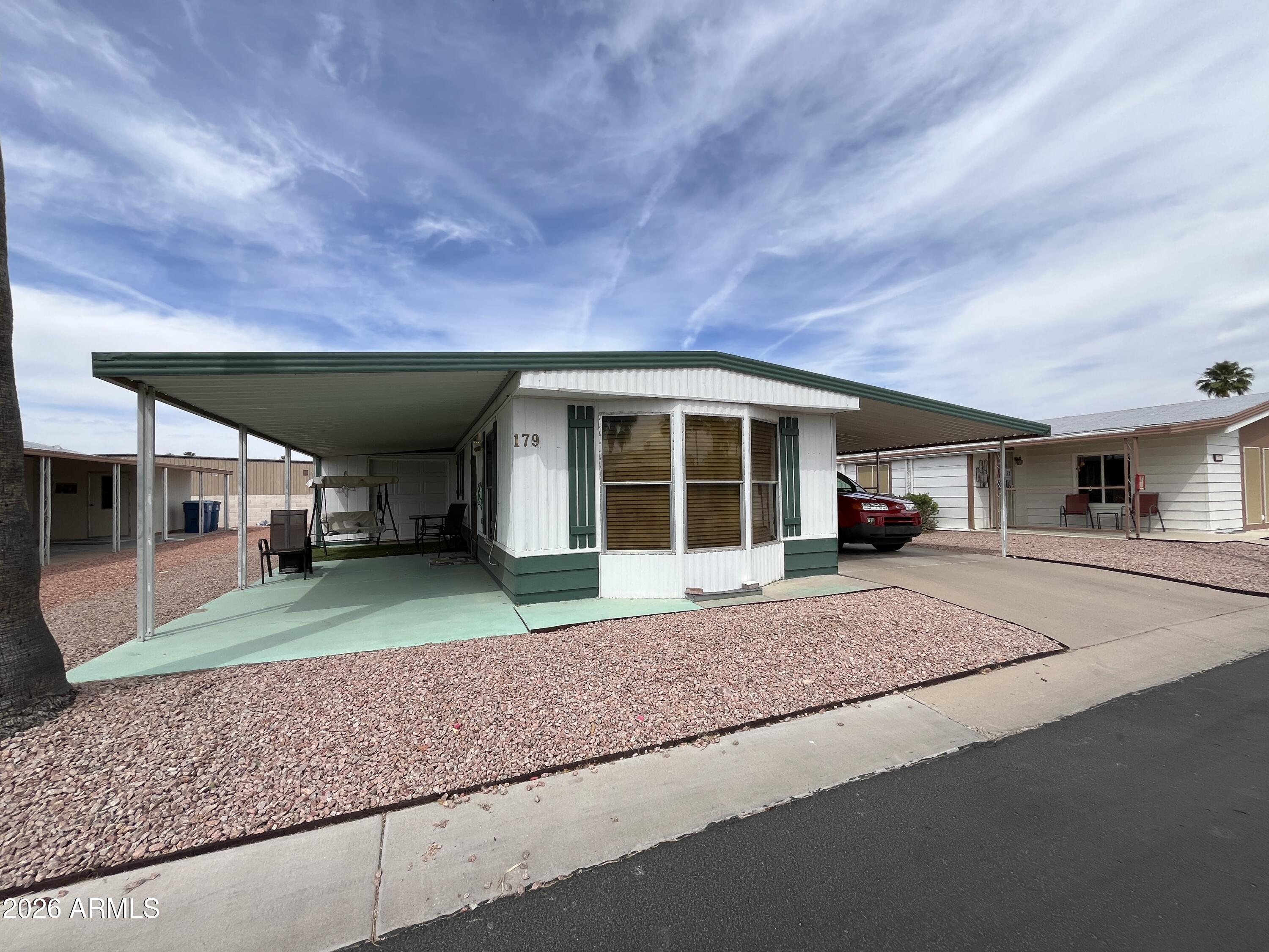 9302 East Broadway Road, Unit 179 Mesa, AZ 85208 - Photo 3 of 54 a view of a house with a backyard and porch