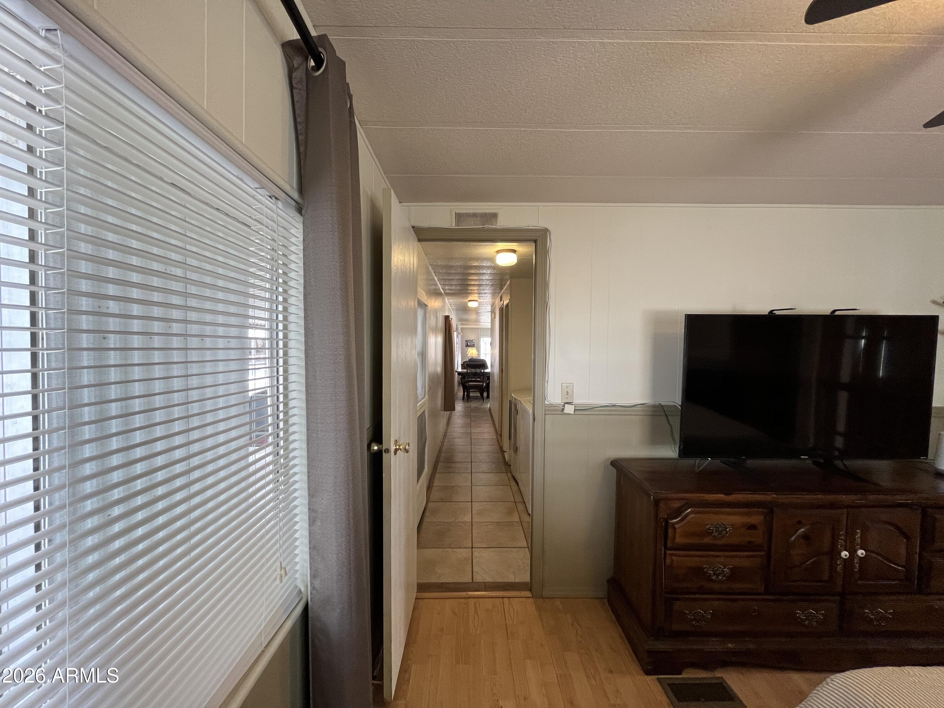 9302 East Broadway Road, Unit 179 Mesa, AZ 85208 - Photo 35 of 54 a view of a livingroom with furniture and flat screen tv