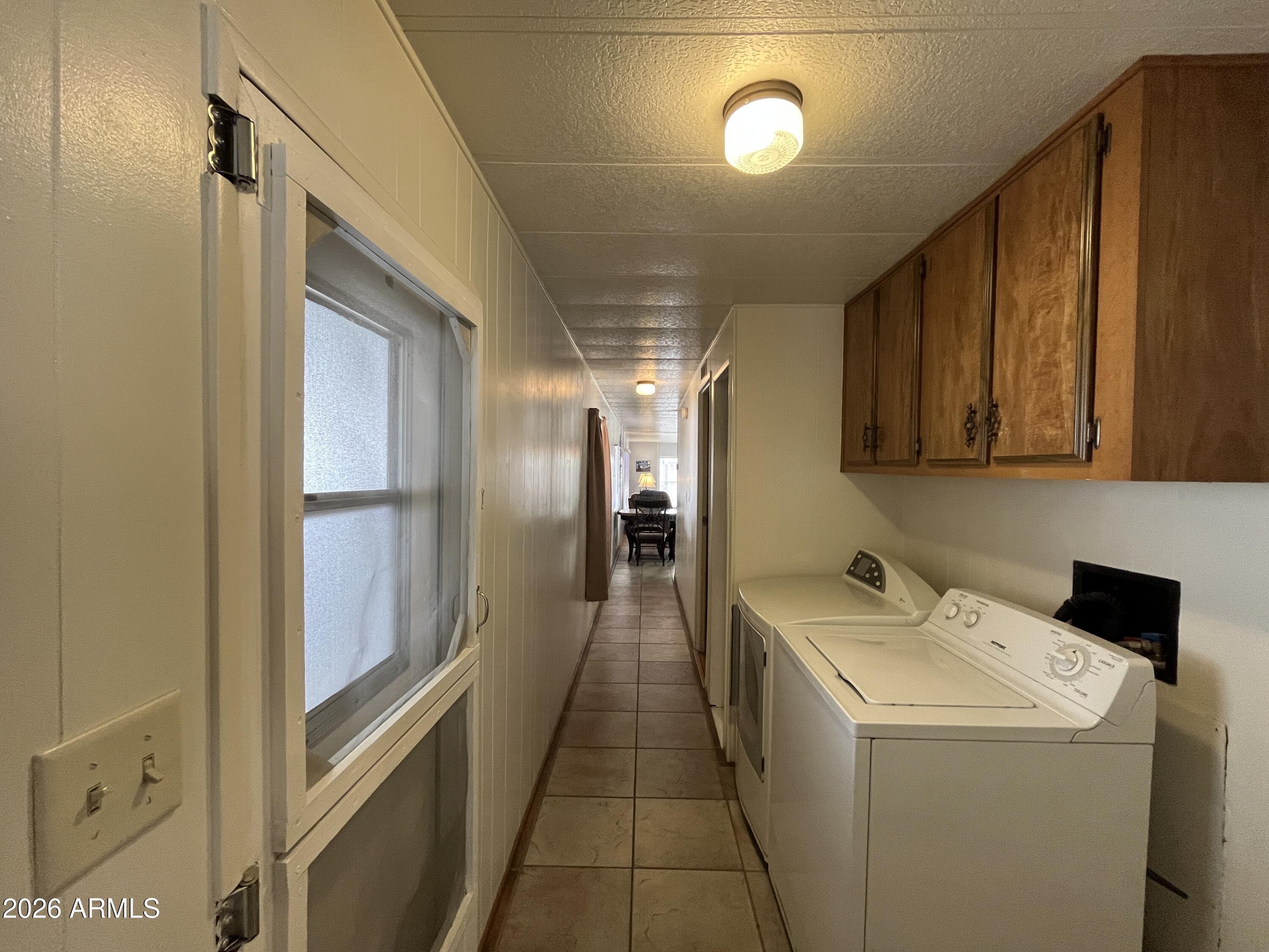 9302 East Broadway Road, Unit 179 Mesa, AZ 85208 - Photo 36 of 54 a hallway with washer and dryer with wooden floor