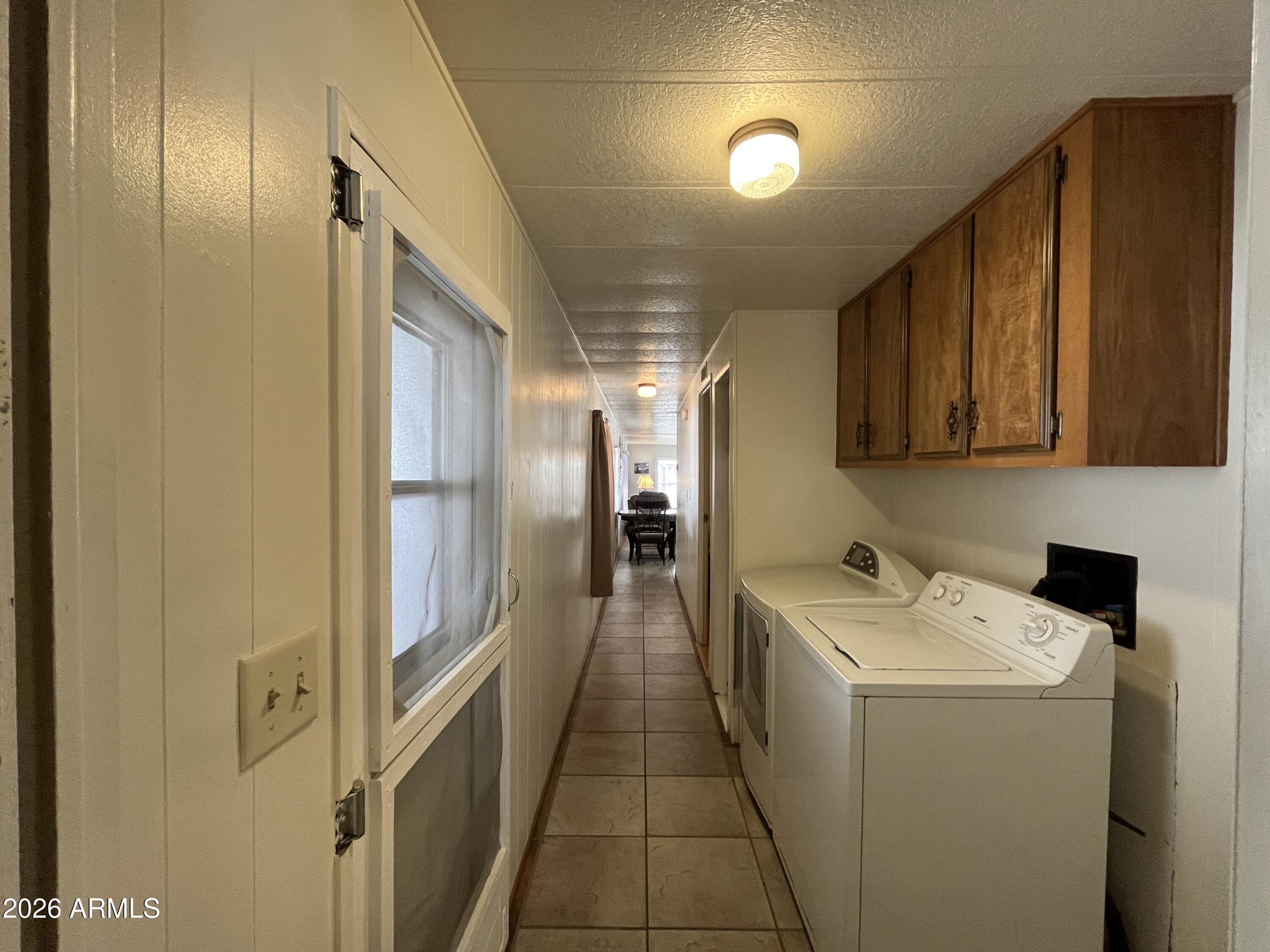 9302 East Broadway Road, Unit 179 Mesa, AZ 85208 - Photo 37 of 54 a hallway with washer and dryer