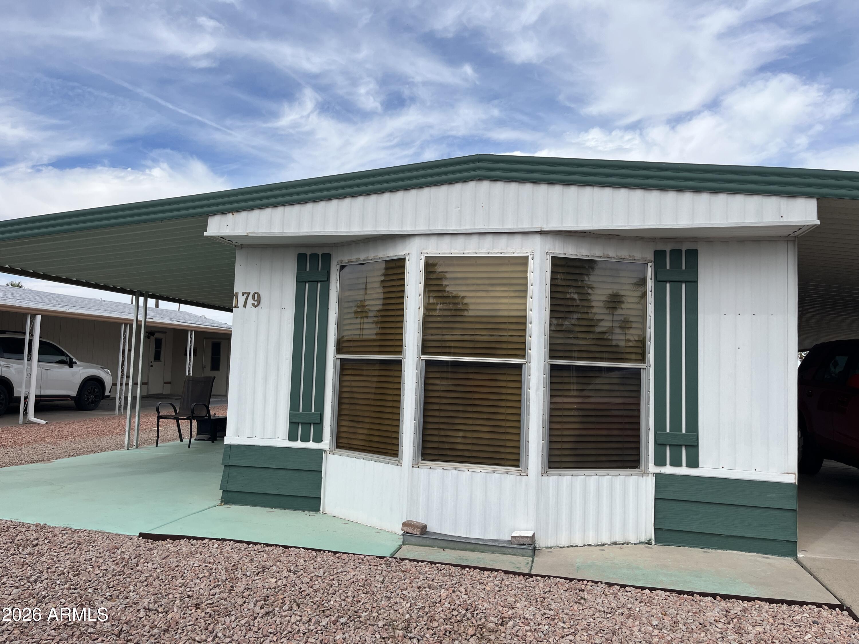9302 East Broadway Road, Unit 179 Mesa, AZ 85208 - Photo 4 of 54 a backyard of a house with oven and outdoor seating