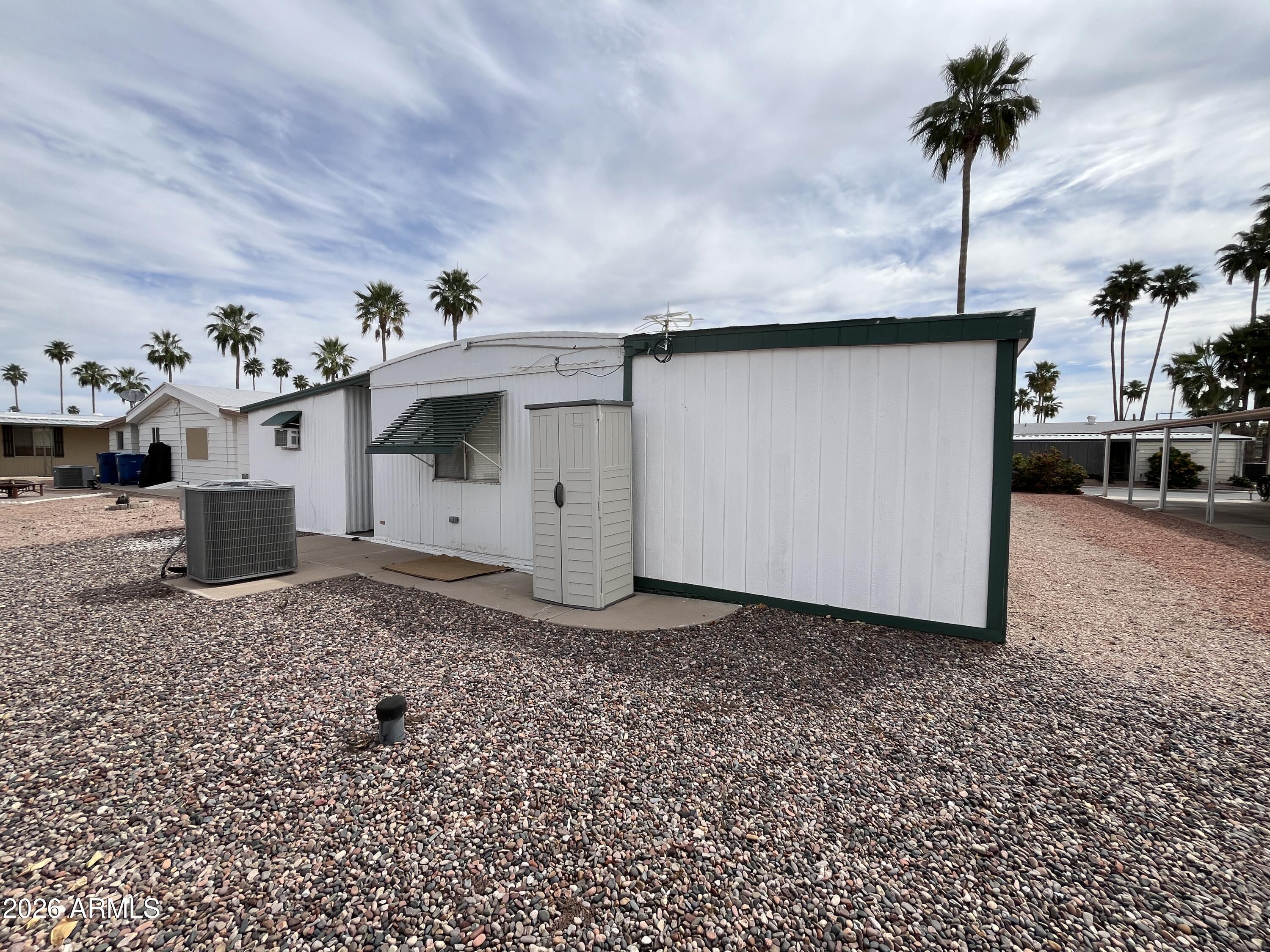9302 East Broadway Road, Unit 179 Mesa, AZ 85208 - Photo 48 of 54 a white house with a sink and chandelier