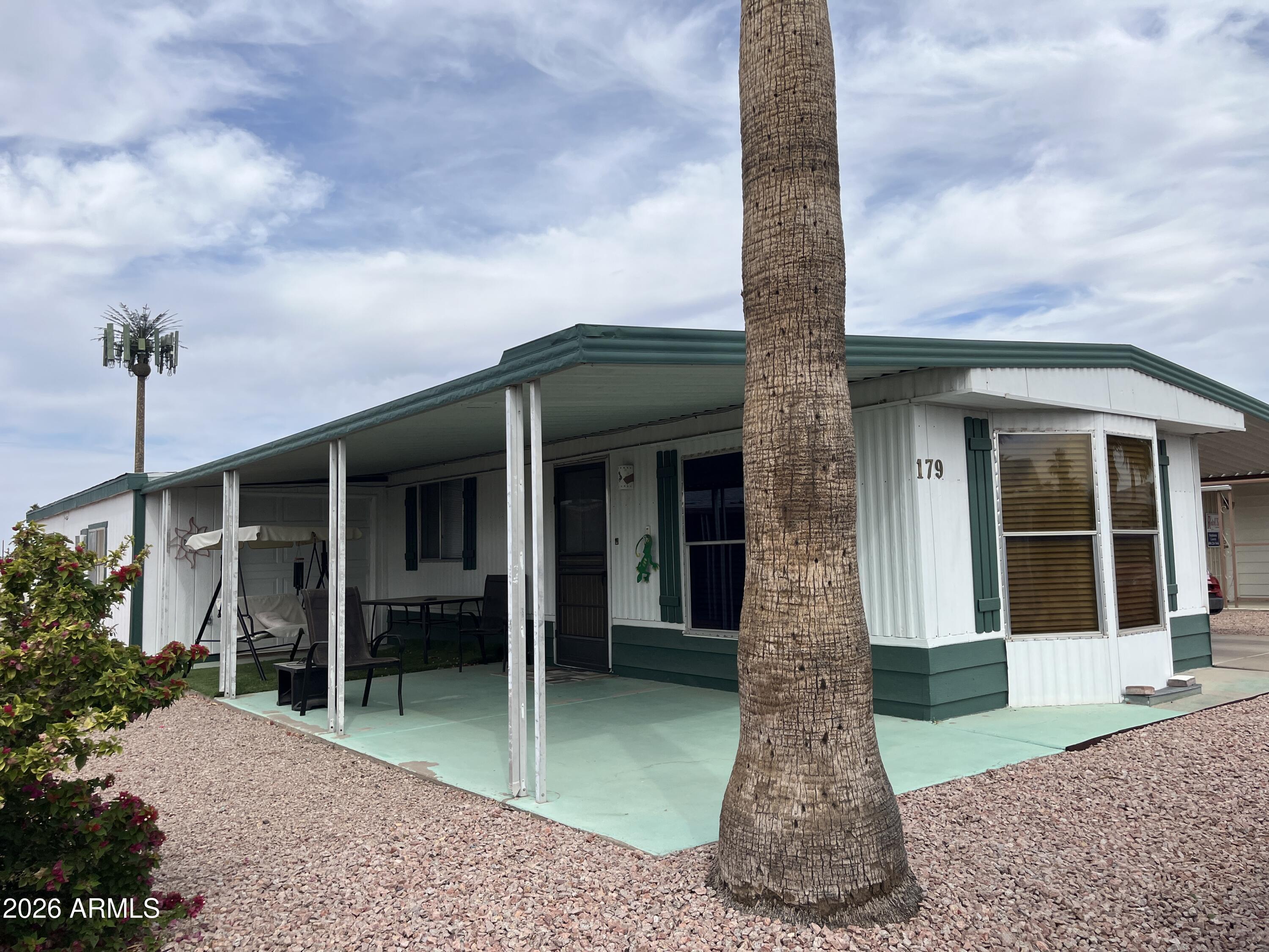 9302 East Broadway Road, Unit 179 Mesa, AZ 85208 - Photo 5 of 54 a front view of a house with a garden