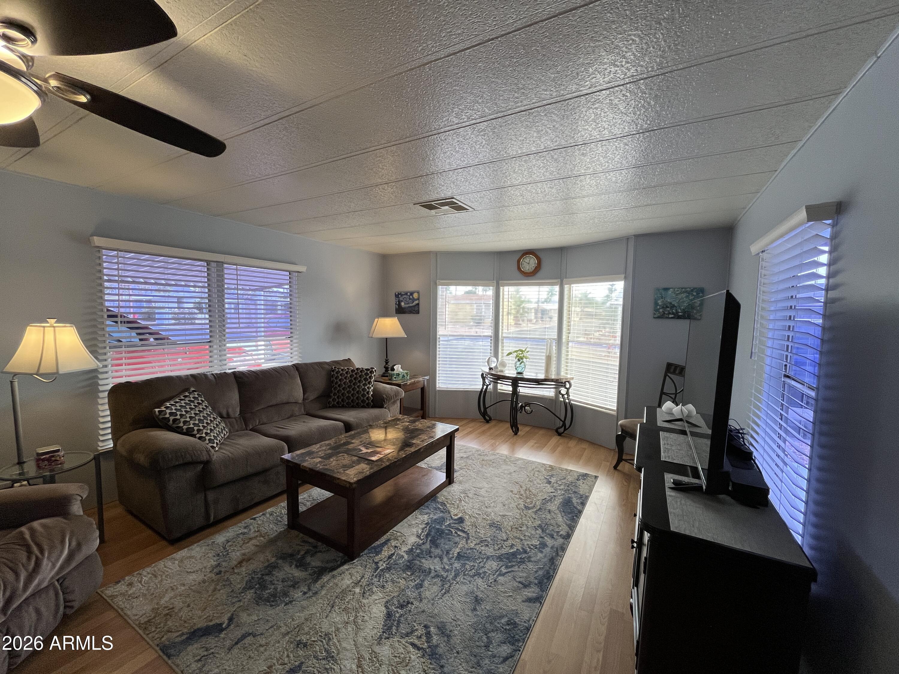 9302 East Broadway Road, Unit 179 Mesa, AZ 85208 - Photo 7 of 54 a living room with furniture and a flat screen tv