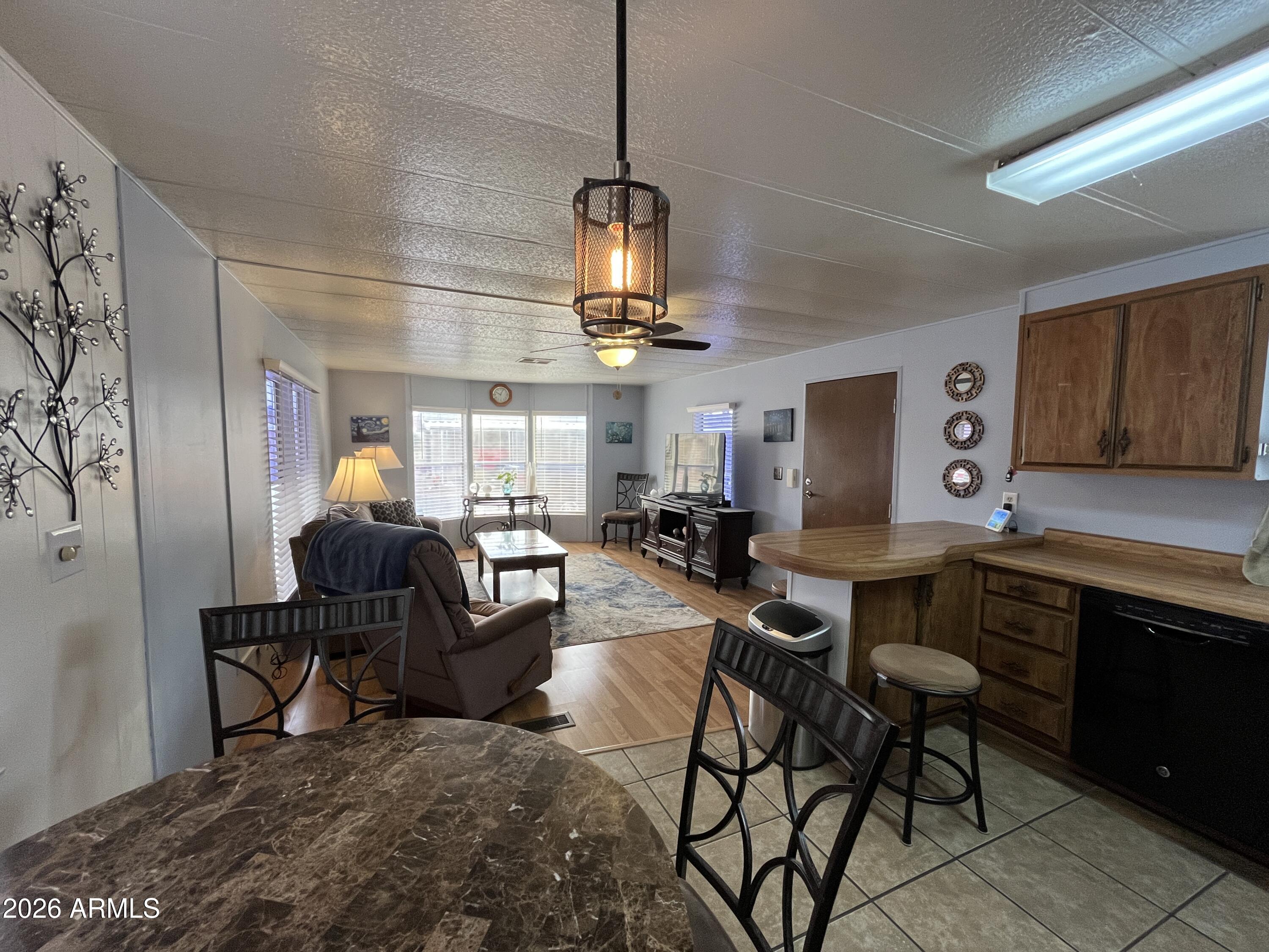 9302 East Broadway Road, Unit 179 Mesa, AZ 85208 - Photo 10 of 54 a living room with lots of furniture and white walls
