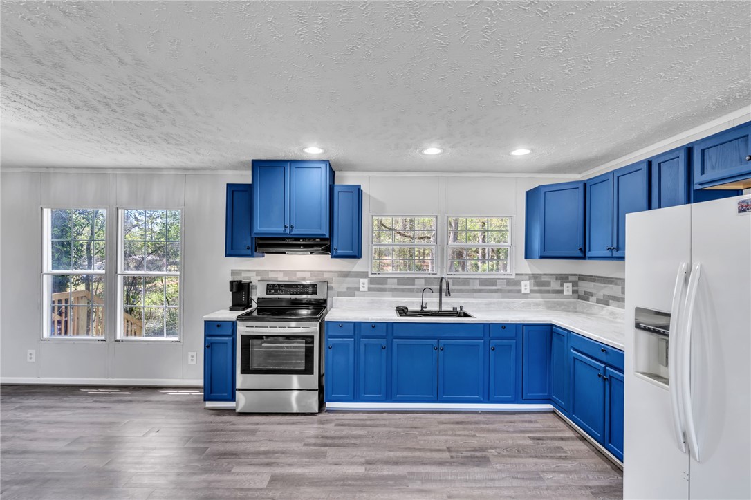 119 Ray Drive Pickens, SC 29671 - Photo 8 of 27 This spacious kitchen offers ample cabinetry, modern appliances, and abundant natural light.