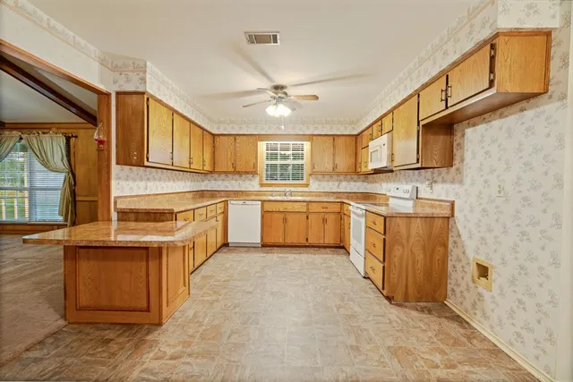 a kitchen with stainless steel appliances granite countertop a stove sink and cabinets