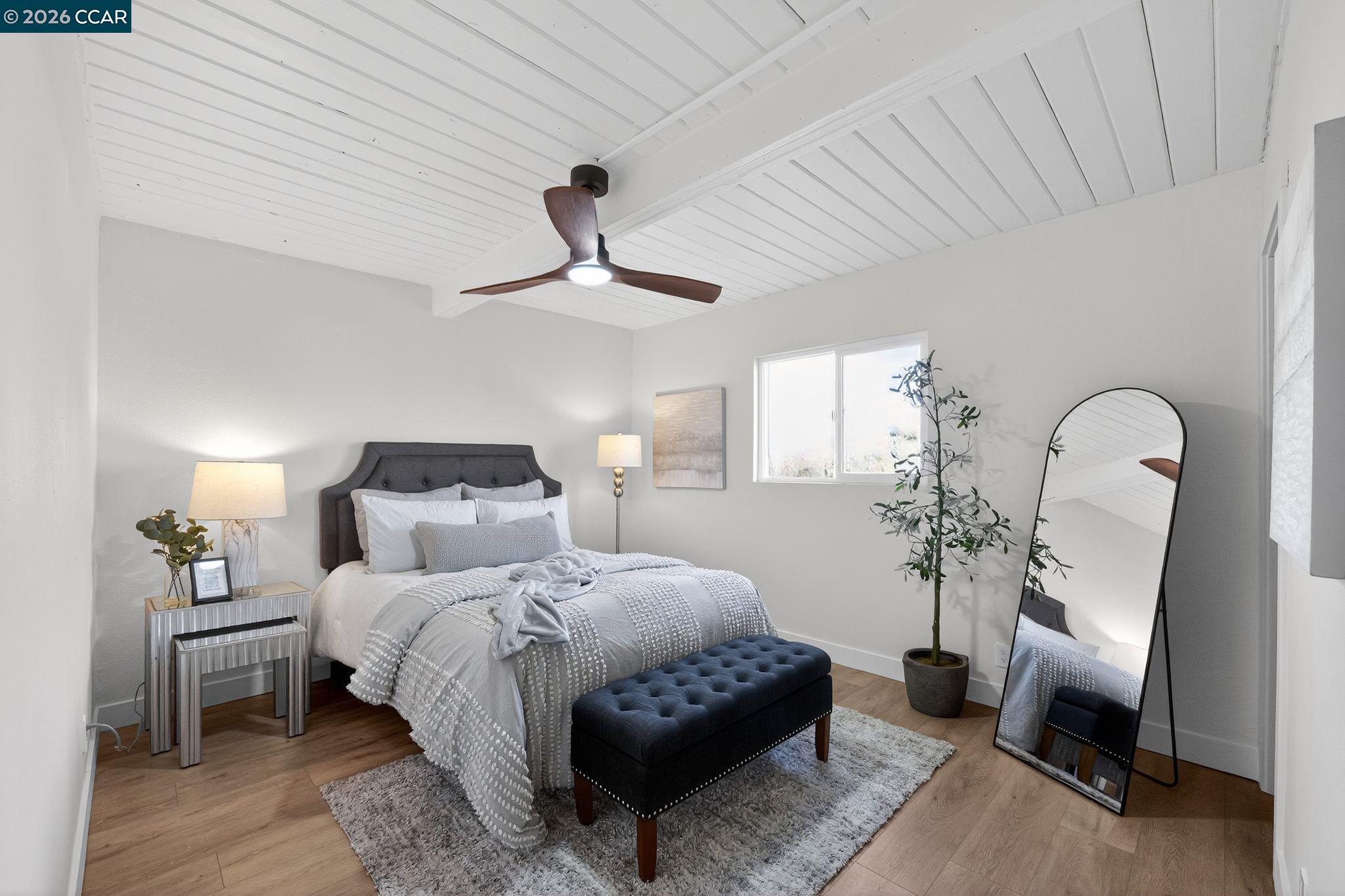 87 Bay Drive Bay Point, CA 94565 - Photo 14 of 22 a bedroom with a bed a chandelier and a mirror on dresser