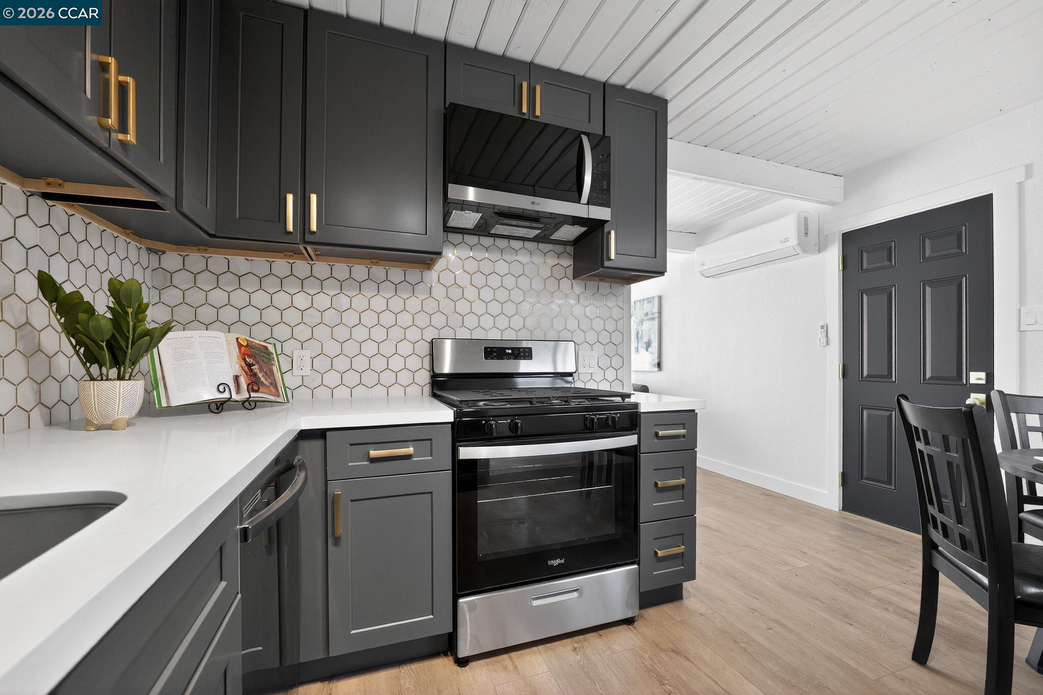 87 Bay Drive Bay Point, CA 94565 - Photo 2 of 22 a kitchen with stainless steel appliances a stove a microwave a sink and cabinets