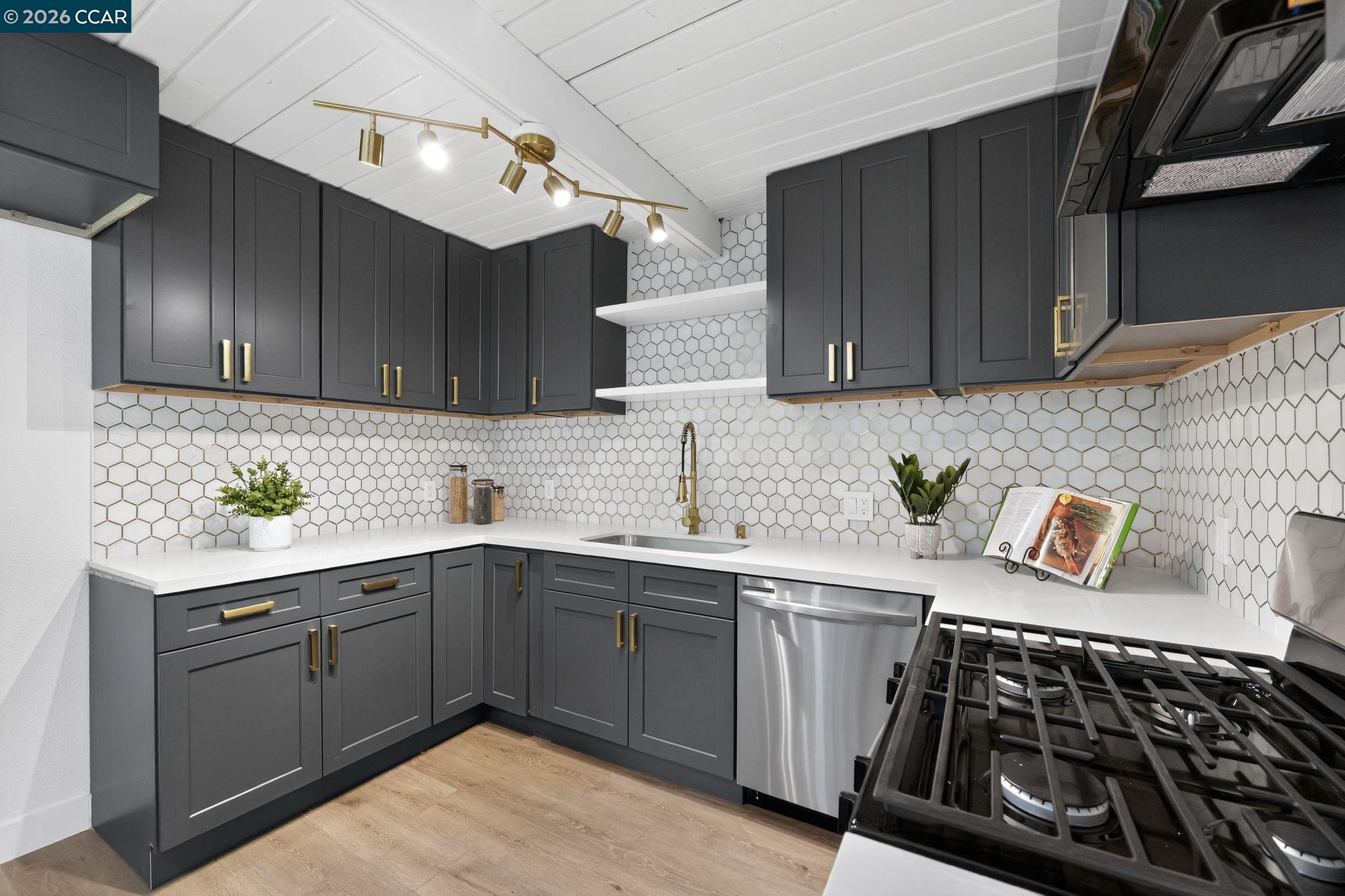 87 Bay Drive Bay Point, CA 94565 - Photo 3 of 22 a kitchen with a sink stove top oven and cabinets