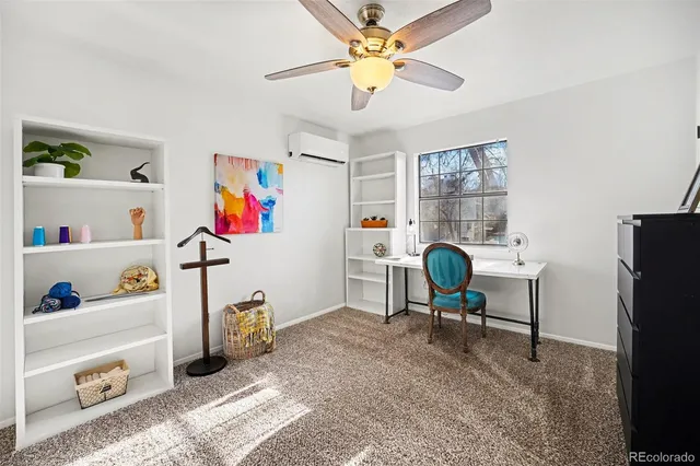 a living room with furniture cabinets and a window