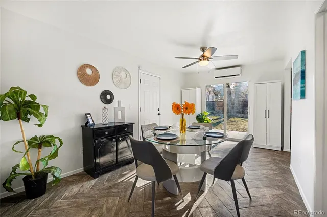 a dining room with furniture a chandelier and a window