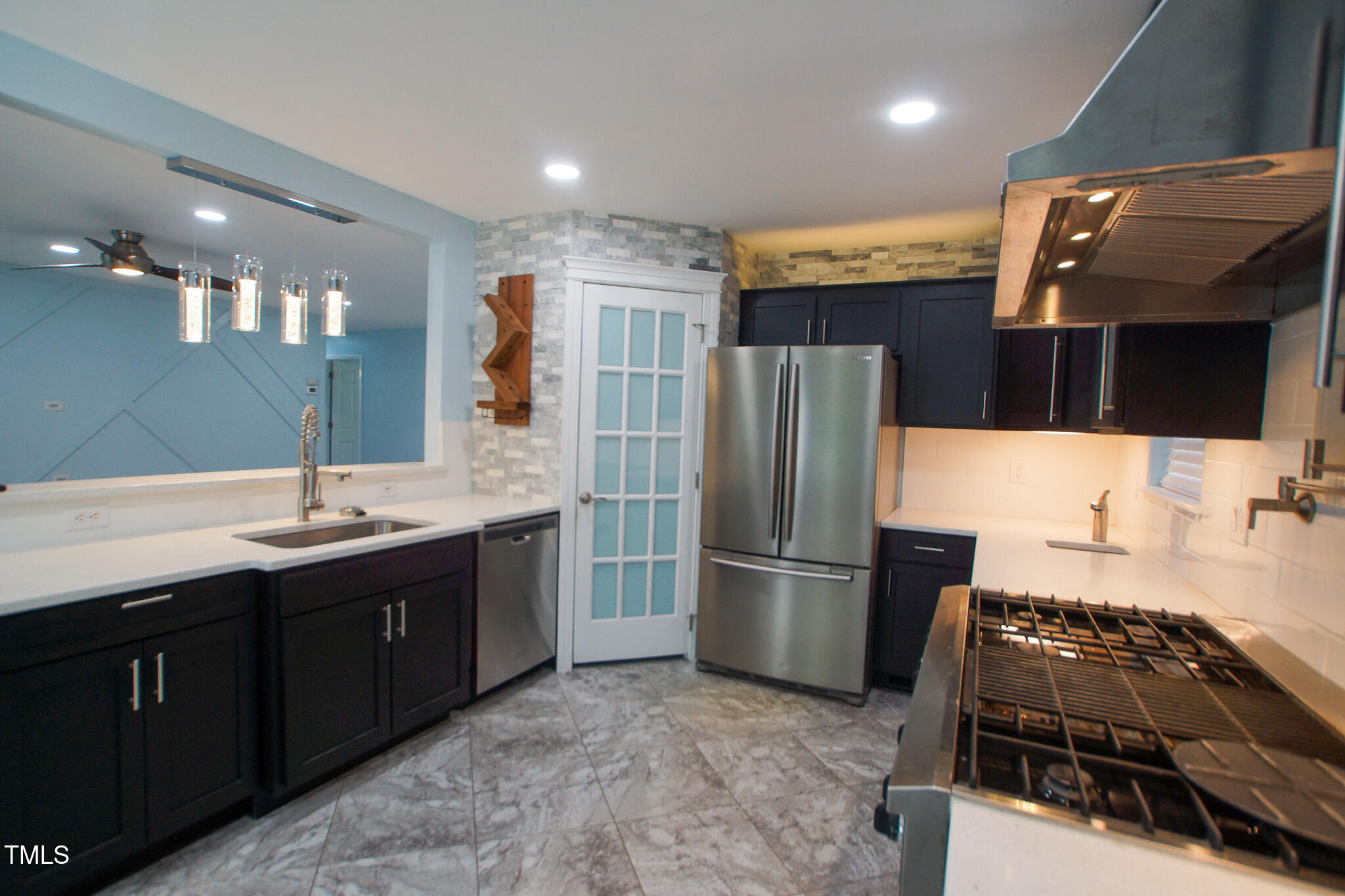 5705 Katha Drive Holly Springs, NC 27540 - Photo 11 of 27 a kitchen with stainless steel appliances granite countertop a refrigerator and a sink