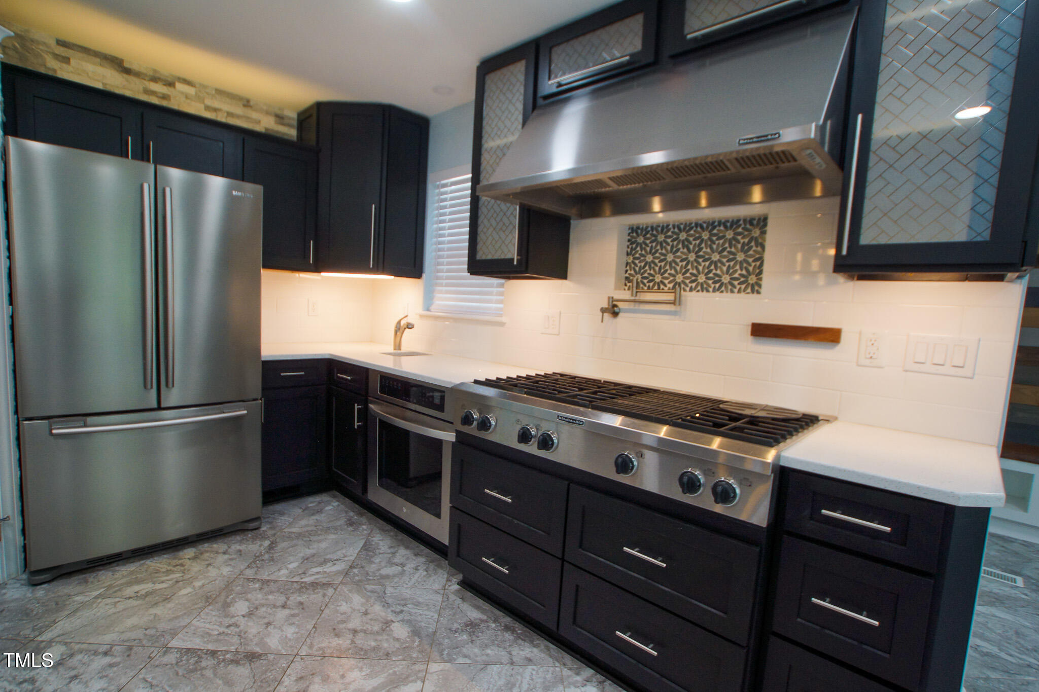 5705 Katha Drive Holly Springs, NC 27540 - Photo 16 of 27 a kitchen with stainless steel appliances granite countertop a refrigerator and a stove