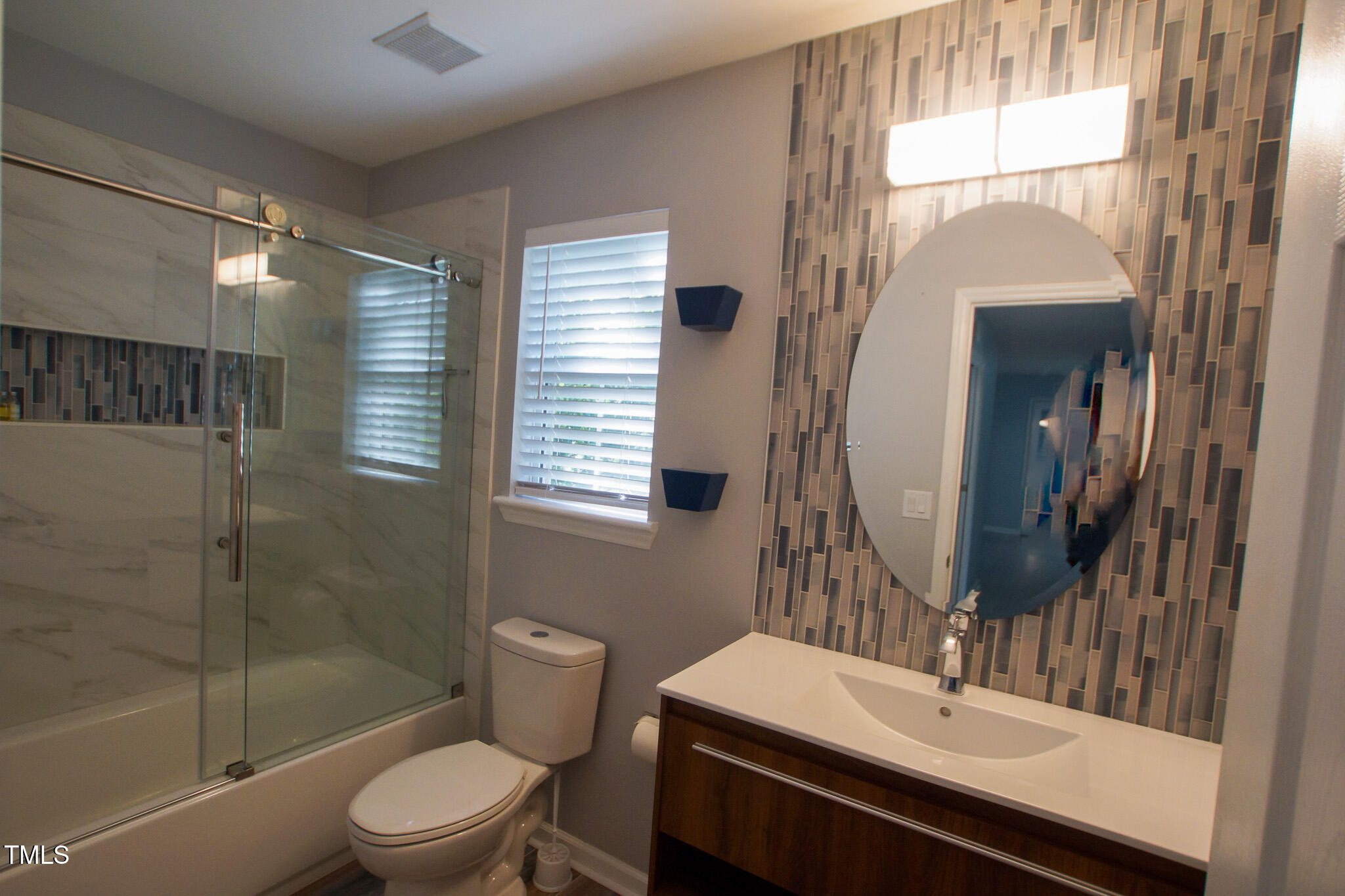 5705 Katha Drive Holly Springs, NC 27540 - Photo 24 of 27 a bathroom with a sink a toilet and shower