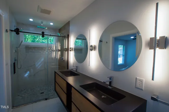 a bathroom with a double vanity sink and a mirror