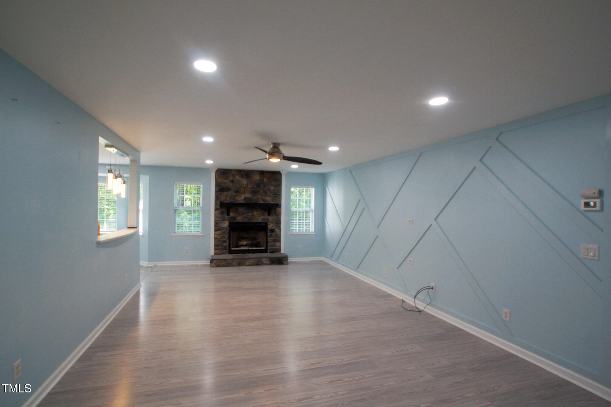 5705 Katha Drive Holly Springs, NC 27540 - Photo 4 of 27 an empty room with furniture and a fireplace