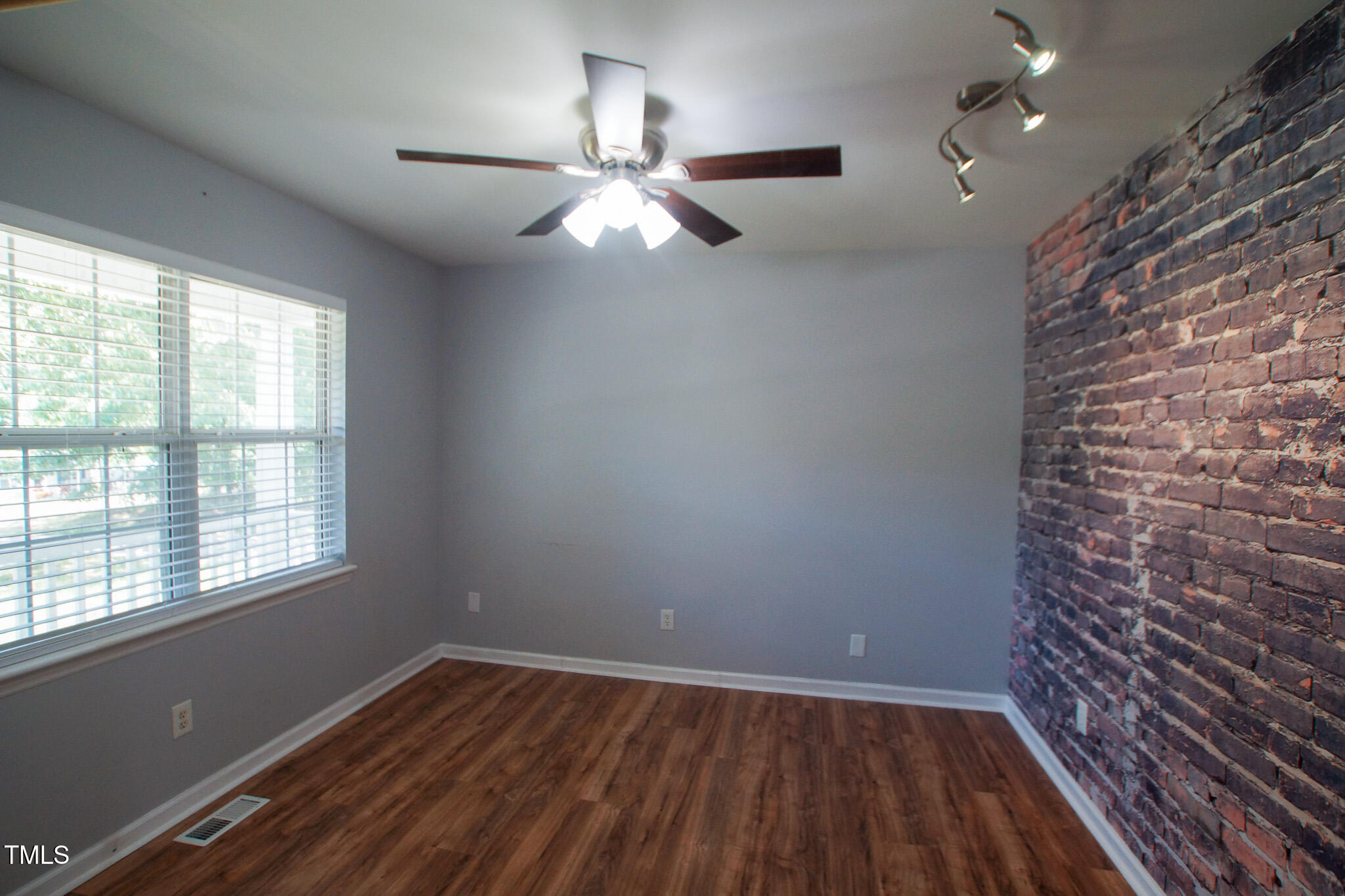 5705 Katha Drive Holly Springs, NC 27540 - Photo 7 of 27 an empty room with wooden floor fan and windows
