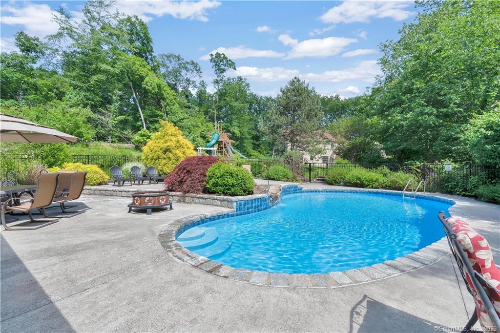 5 Lake Road Newtown, CT 06470 - Photo 1 of 1 a view of a swimming pool with a patio and plants