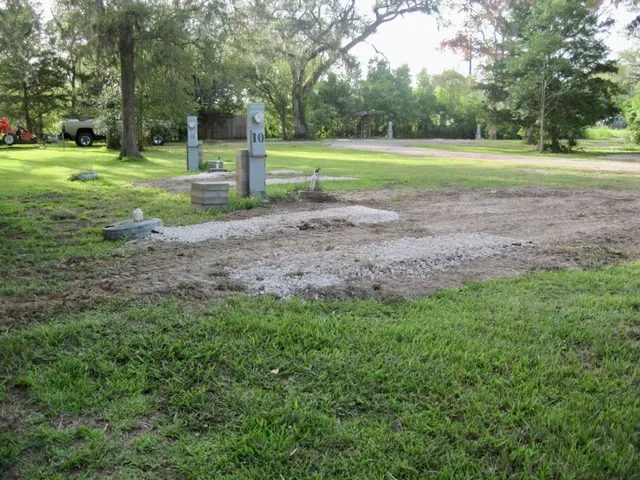 a view of a house with backyard and trees