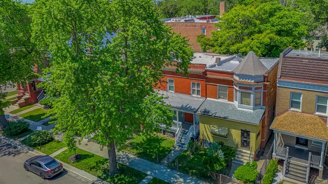 an aerial view of a house with yard and garage