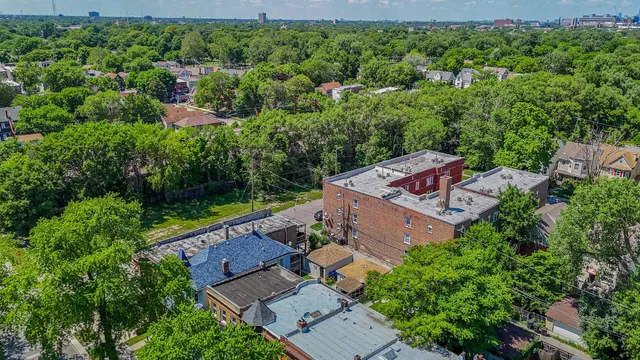 an aerial view of a house with a yard