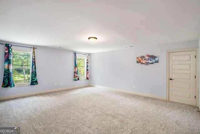 a view of a house with large windows and a yard