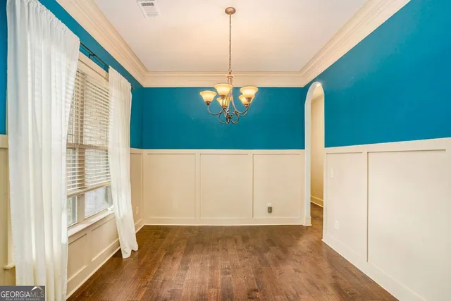a kitchen with a table chairs stove and refrigerator