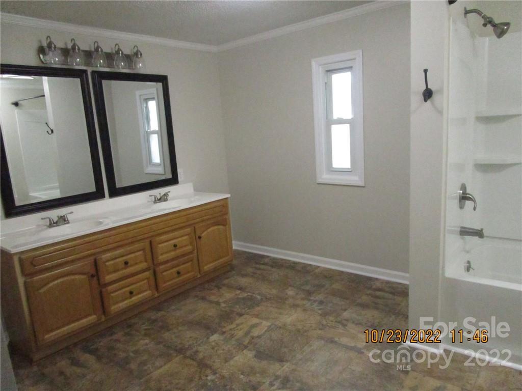 2605 Hinson Road, Unit P1 Monroe, NC 28112 - Photo 12 of 18 a bathroom with a double vanity sink and a mirror