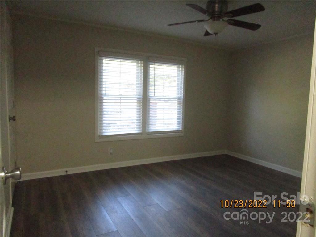 2605 Hinson Road, Unit P1 Monroe, NC 28112 - Photo 15 of 18 an empty room with wooden floor and windows