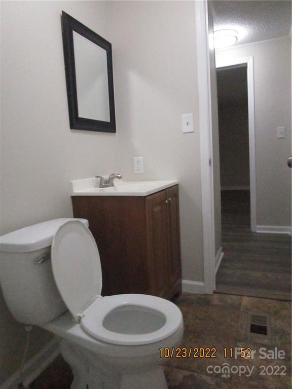 2605 Hinson Road, Unit P1 Monroe, NC 28112 - Photo 16 of 18 a bathroom with a toilet a sink and mirror