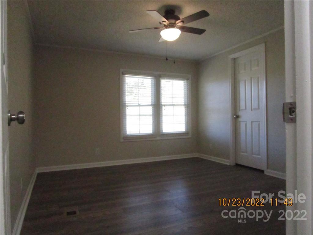 2605 Hinson Road, Unit P1 Monroe, NC 28112 - Photo 18 of 18 a view of empty room with wooden floor and fan