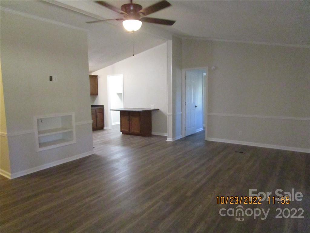 2605 Hinson Road, Unit P1 Monroe, NC 28112 - Photo 4 of 18 an empty room with wooden floor fireplace and windows