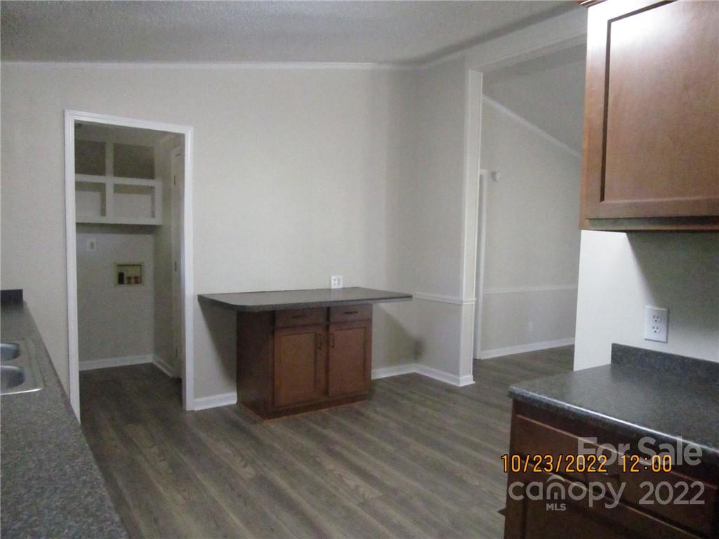 2605 Hinson Road, Unit P1 Monroe, NC 28112 - Photo 6 of 18 a view of an empty room with wooden floor and a window
