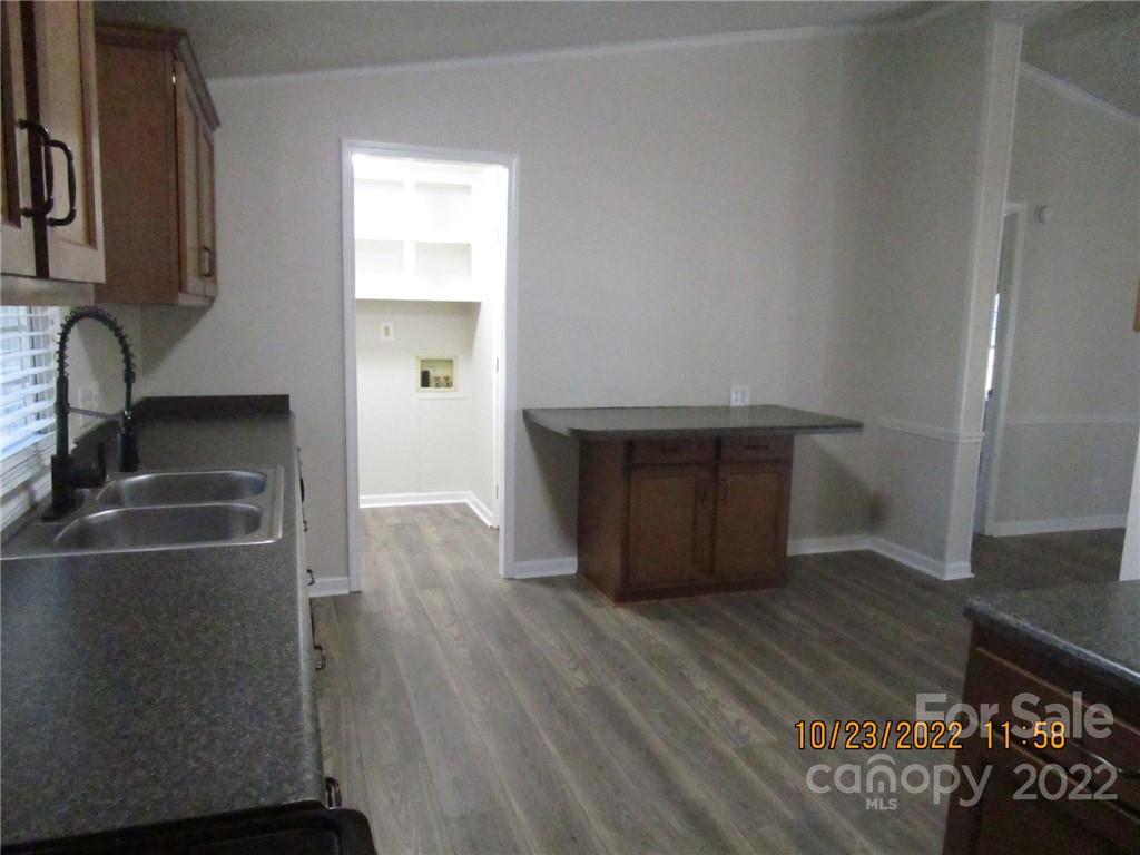 2605 Hinson Road, Unit P1 Monroe, NC 28112 - Photo 8 of 18 a kitchen with wooden floors and a sink