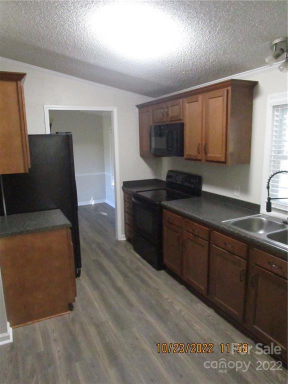 2605 Hinson Road, Unit P1 Monroe, NC 28112 - Photo 9 of 18 a kitchen with stainless steel appliances granite countertop a sink a stove a refrigerator a microwave a sink and cabinets