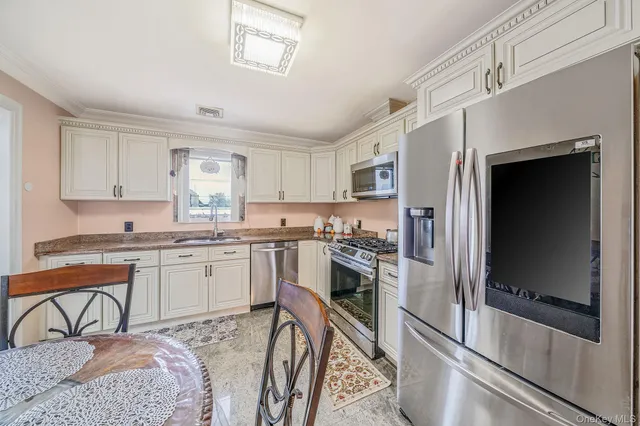 a view of a dining room with furniture and a window
