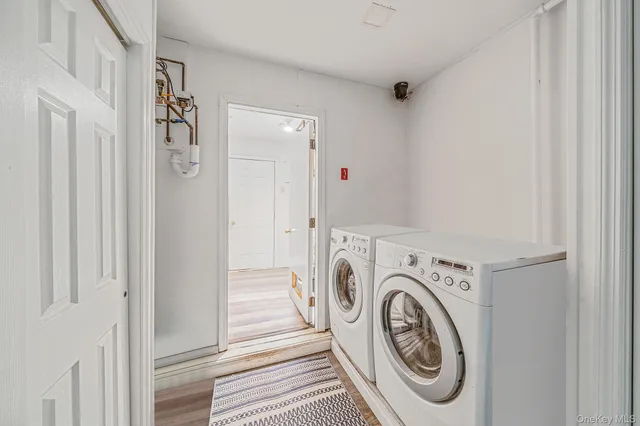 a view of a hallway with wooden floor and entryway
