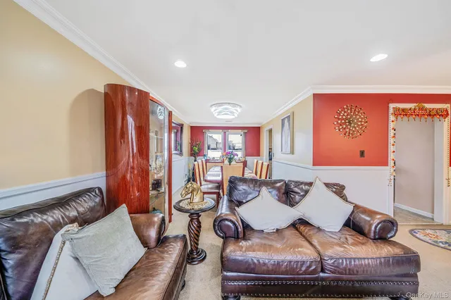 a dining room with furniture and a potted plant