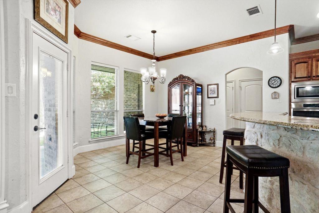 620 Highview Lane Hurst, TX 76054 - Photo 17 of 40 a view of a dining room with furniture and chandelier