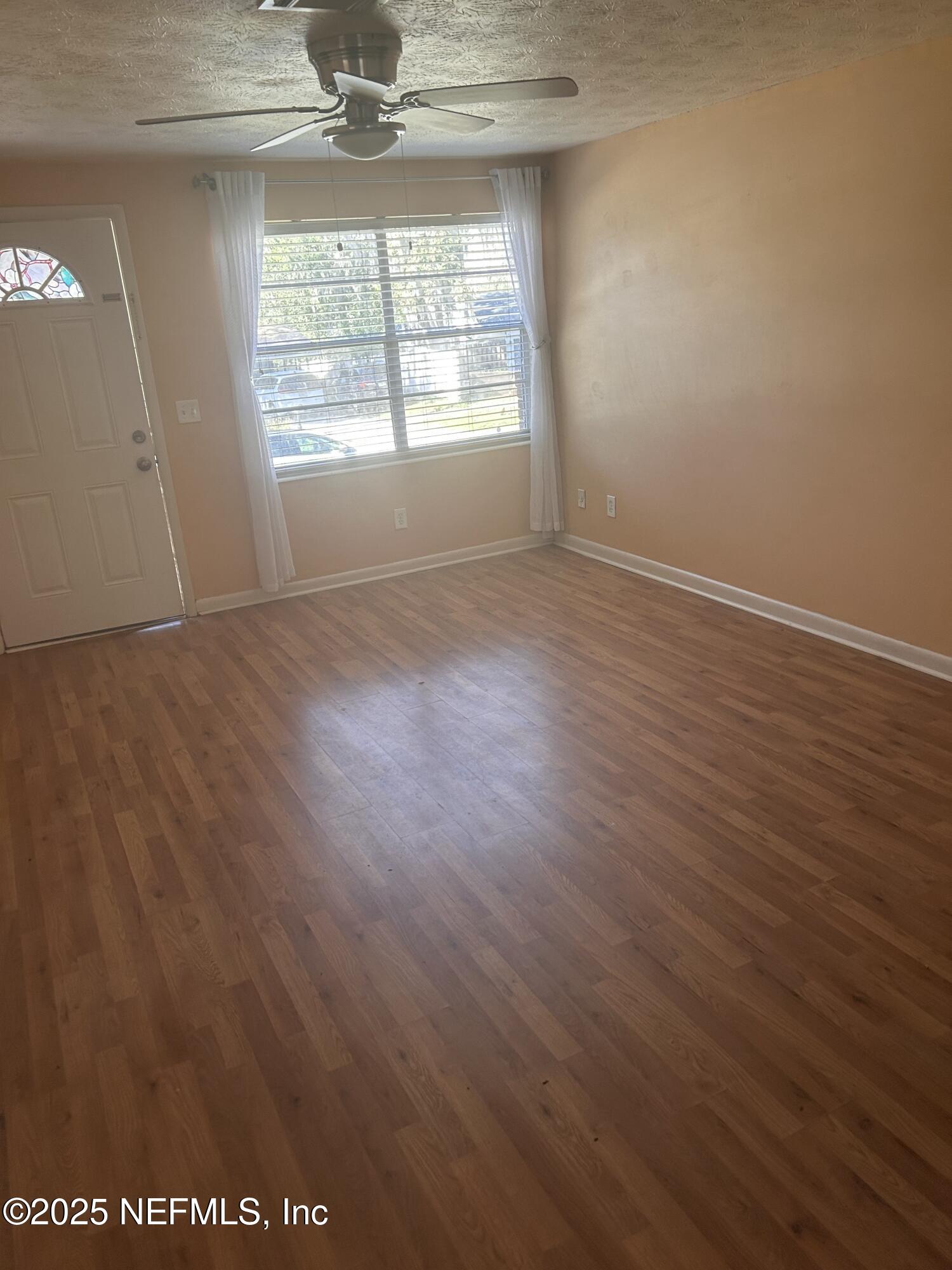 258 Capella Road Orange Park, FL 32073 - Photo 2 of 15 an empty room with wooden floor and windows