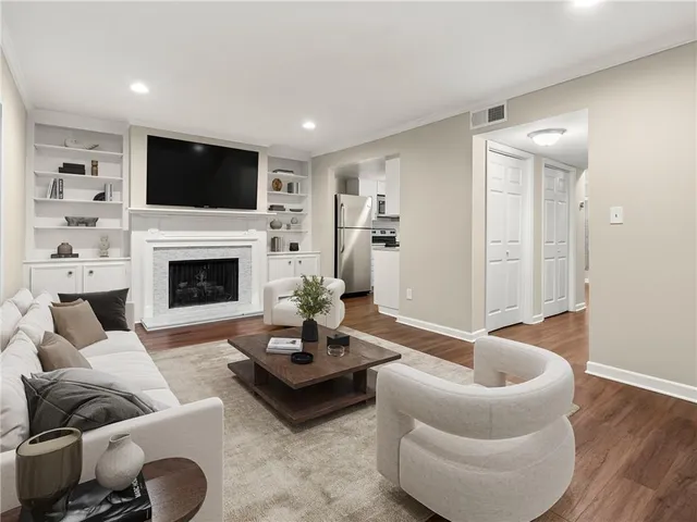 a living room with furniture a fireplace and a flat screen tv