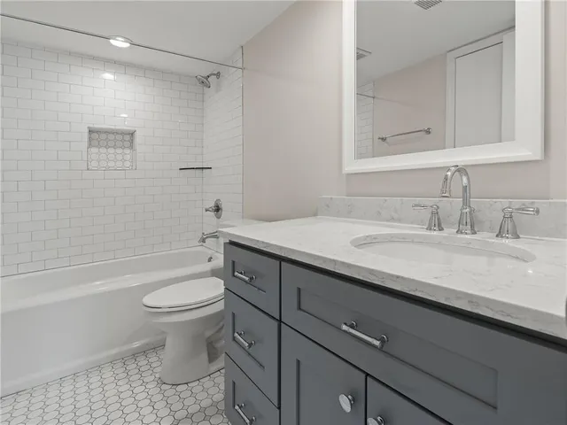 a bathroom with a sink a toilet and bathtub