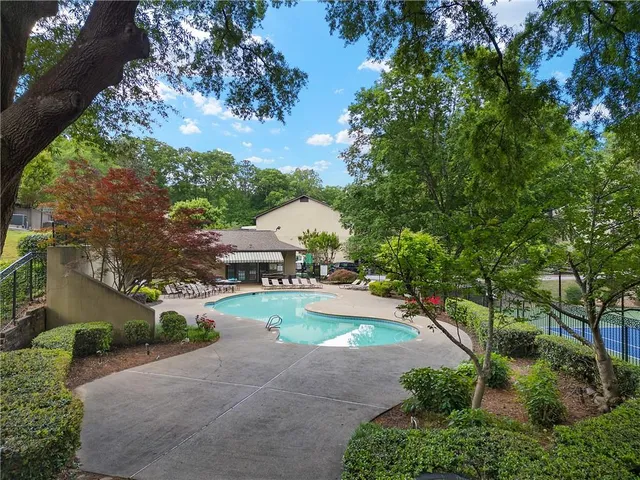 an aerial view of a house with yard and green space