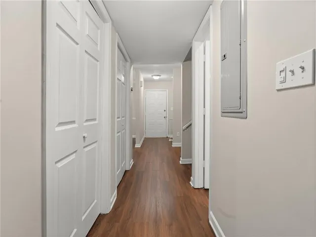 a view of a hallway with wooden floor and staircase