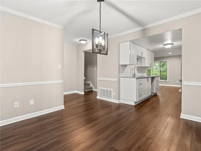 a view of a kitchen with wooden floor