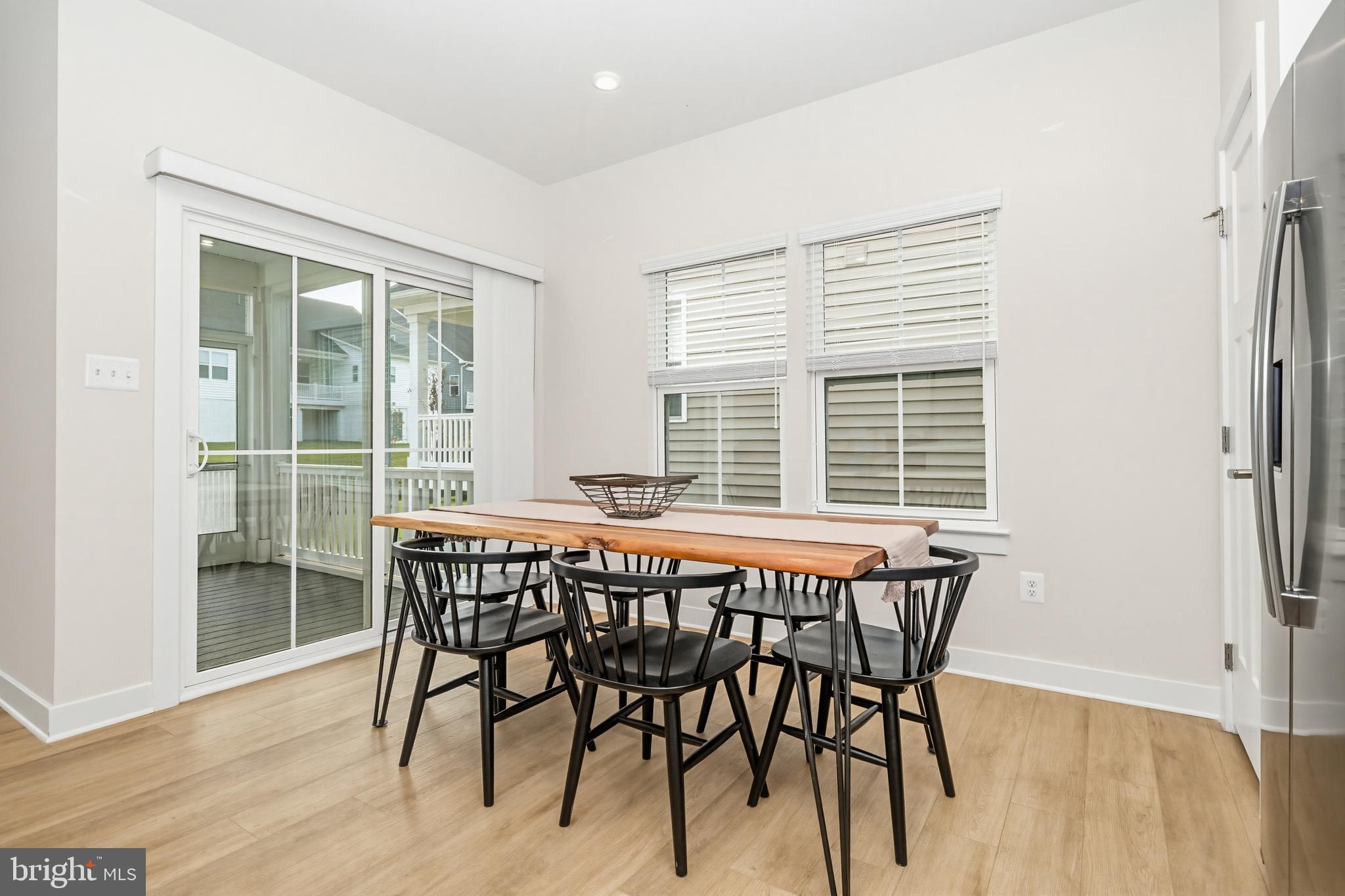 1326 Stonefly Lane Odenton, MD 21113 - Photo 16 of 48 a view of a dining room with furniture and wooden floor